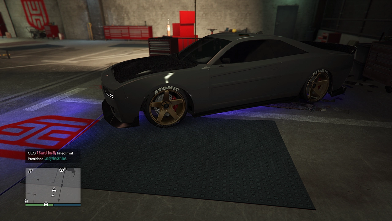 A dark grey Bravado Buffalo EVX muscle car is parked inside the LS Car Meet as the premium test drive vehicle.