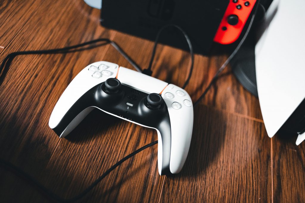 PS5 controller on wooden desk