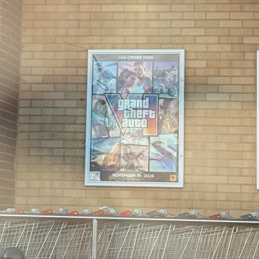 A GTA VI poster on a brick wall.