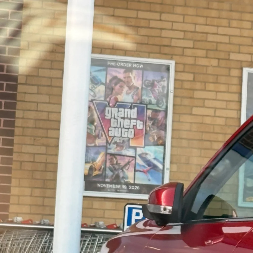 A GTA VI poster on a brick wall.
